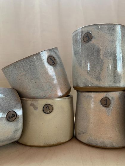 Another stack of our custom-stamped studio cups. They are a constant reminder of our brand and our journey.