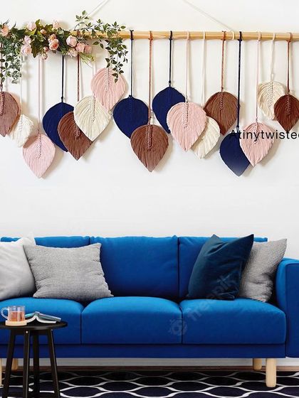 Here is one of my leaf wall hangings styled above a modern blue sofa. The contrast of the navy, brown, and pink leaves against the blue fabric is just stunning.