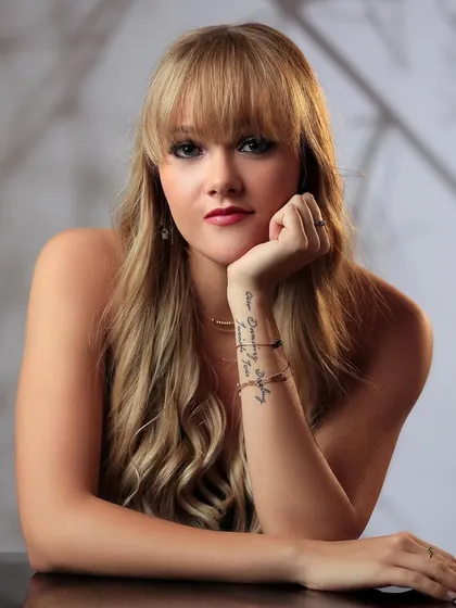 Another headshot from the same series, showing the model's tattoo and a thoughtful expression.