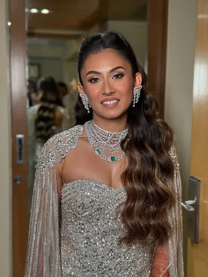 A full-sparkle look for an engagement celebration. The makeup was designed to complement her diamond jewelry and shimmering gown, featuring a flawless base, sculpted features, and a touch of drama in the eyes. It's all about creating that head-turning goddess mode.