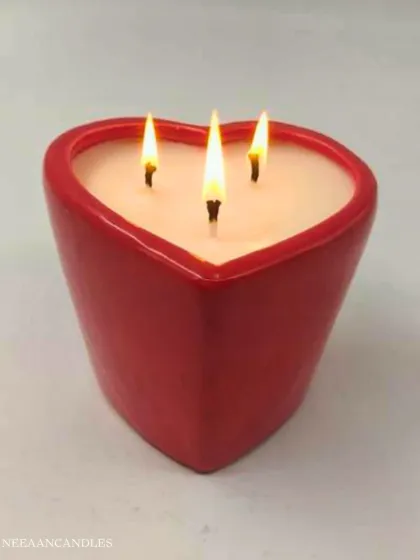 A little jar of love, ready to light up your moments. This red heart-shaped ceramic jar holds a three-wick candle.