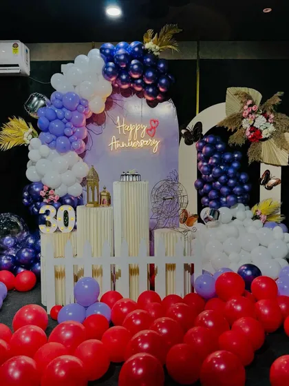 This wide shot shows the full 30th anniversary decoration, with red balloons scattered on the floor to add a pop of color and fill the space. We can customize the color scheme to match your preference.