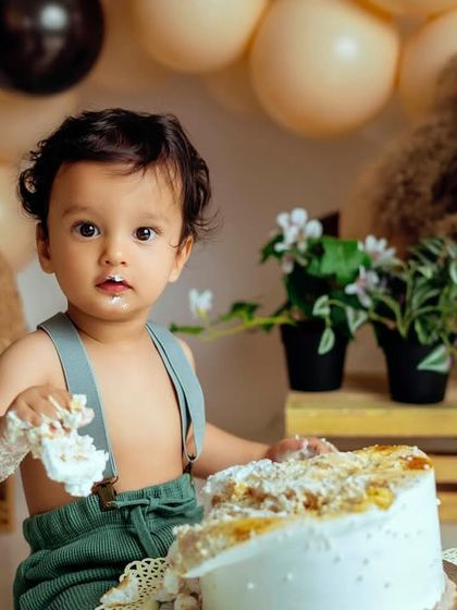 That moment of realization when they figure out the cake is all for them. This boho setup provides a beautiful, neutral backdrop for these priceless first birthday memories.