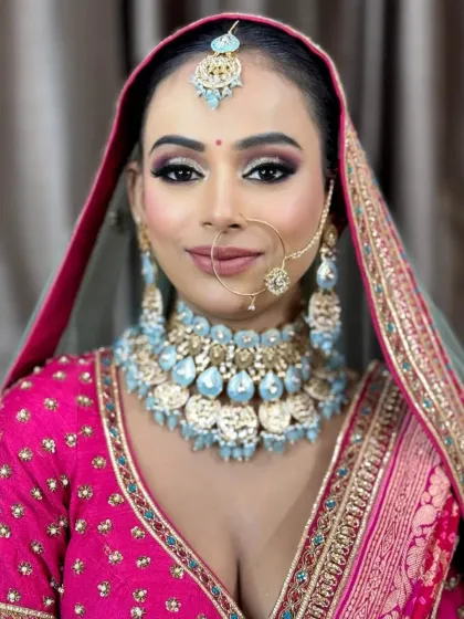 A confident and direct look from the bride. Her makeup is bold and beautiful, designed to stand out and complement her colorful attire.