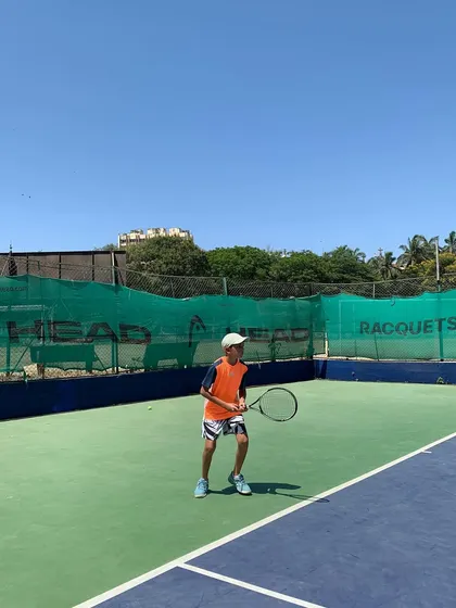 A young player in a ready position, anticipating the next shot during the TenniStation Season 12 tournament.