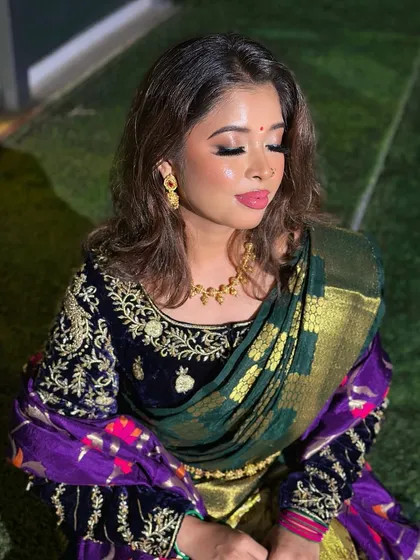 A close-up with eyes closed, highlighting the flawless eyeshadow blending and the dewy skin finish.