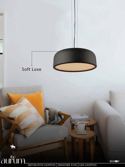 The 'Soft Luxe' drum pendant in black provides a gentle, diffused downlight. It's a perfect choice for creating a cozy, intimate atmosphere in a reading nook or over a small seating area.