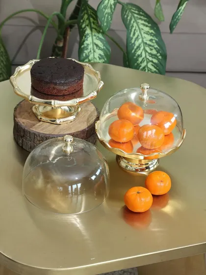 Our golden dessert stands with glass cloches, perfect for showcasing individual cakes or fruits. The polished gold finish and classic design add a touch of opulence to any dessert presentation.
