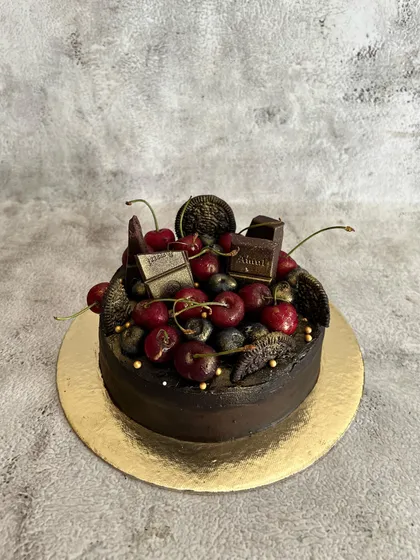 A decadent Belgian chocolate cake made even more luxurious with a topping of fresh, juicy cherries. The combination of rich chocolate and sweet cherries is a classic for a reason.