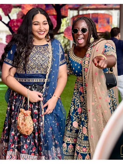 The joy is infectious! Two guests having a fantastic time at our photo booth during a beautiful outdoor wedding ceremony.