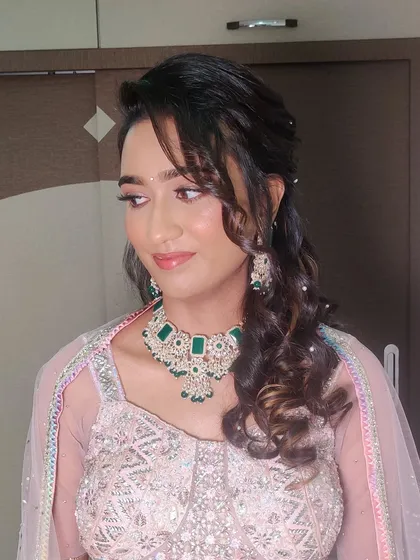 The side profile of Ankita's Sangeet look, showing the soft curls and delicate hair accessories that completed her princess like style.