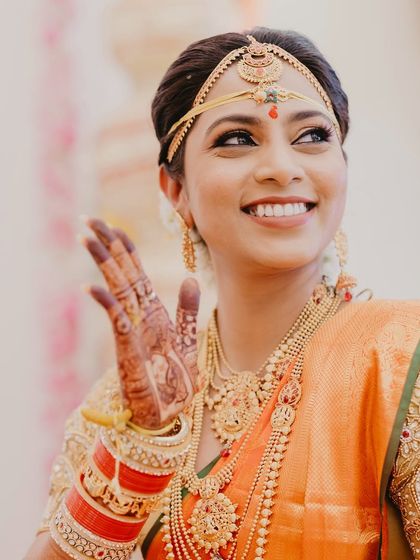 A happy, waving bride. This shot captures her excitement and joy as she greets her family and friends on her special day.