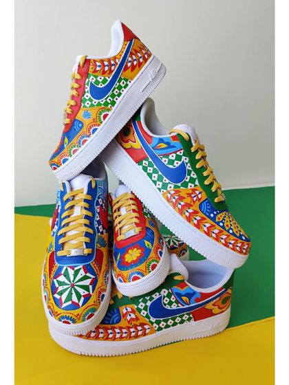 A tower of custom Nike Air Force 1s, all hand-painted with vibrant and colorful Indian truck art motifs. This is one of my favorite styles to paint, full of energy and life.