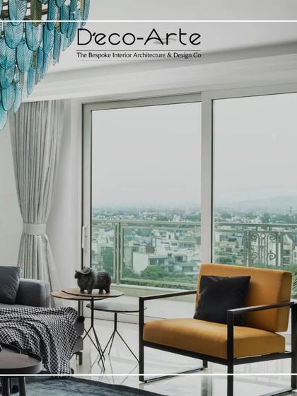 Another view of the spacious living room at DLF Kings Court. The combination of a statement armchair, modern art, and an incredible view makes this a perfect sanctuary.