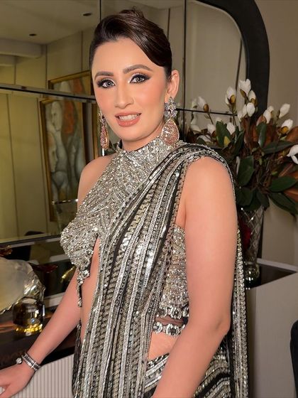 A close-up portrait showing the flawless skin and shimmering eye makeup. This is a perfect example of clean, full glam.