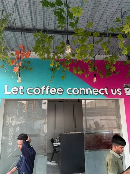 Another shot of the entrance signage, showing how the artwork and hanging plants work together to create an inviting entryway.
