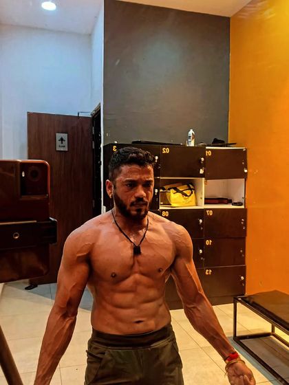 A candid shot in the locker room. Even when not actively posing, a well-built physique shows its structure and definition.