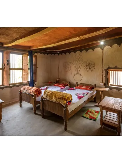Another view of a homestay bedroom, built in collaboration with the local community. The entire process involved knowledge sharing, with elders guiding the construction and younger members providing the labor, resulting in a truly community-built space.