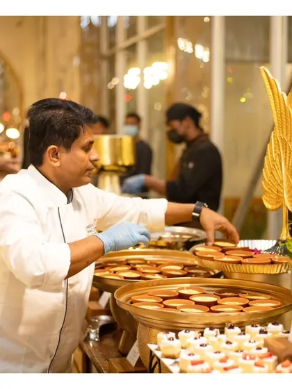 A chef arranging desserts at a live station, showcasing that even our sweet courses can have an interactive element.