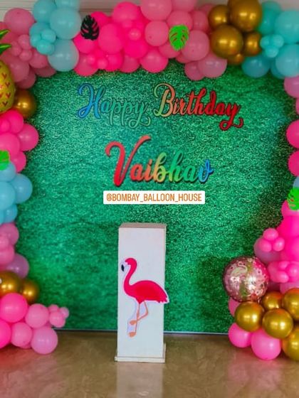 The complete tropical backdrop with a vibrant green grass wall, perfect for a fun and colorful house party.