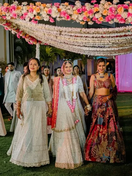 The bride walking down the aisle with her sisters and friends, a beautiful moment of support and love.