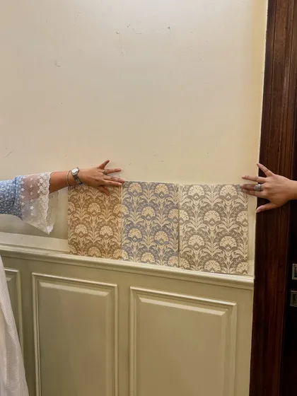 A snapshot of a productive day at the studio. Here, we are reviewing different colorway samples for a wallpaper directly on the client's wall to see how the light and space affect the design before making a final decision.