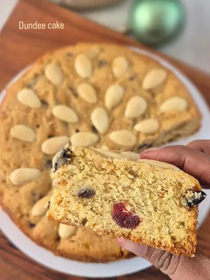 This is a slice of my Dundee Cake, a non-alcoholic Christmas option. It's a lighter fruit cake, characterized by the pattern of blanched almonds on top.