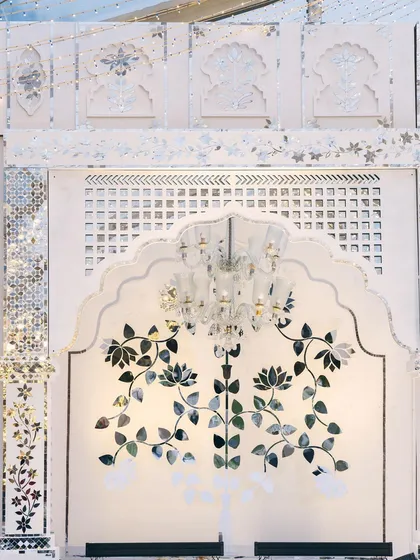 A close-up of the floral motifs within the Thikri mirror work. The design is inspired by traditional Indian patterns, executed with meticulous craftsmanship.