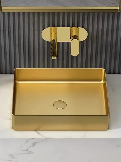 A frontal view of the gold basin and wall-mounted faucet combination. This setup is perfect for a powder room or a master bathroom where you want to make a strong design statement.