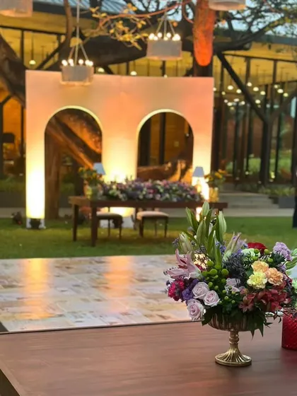 Another view of the outdoor reception, showing the dance floor and the overall layout. We use strategic lighting to highlight the natural beauty of the venue while creating an intimate and celebratory atmosphere.