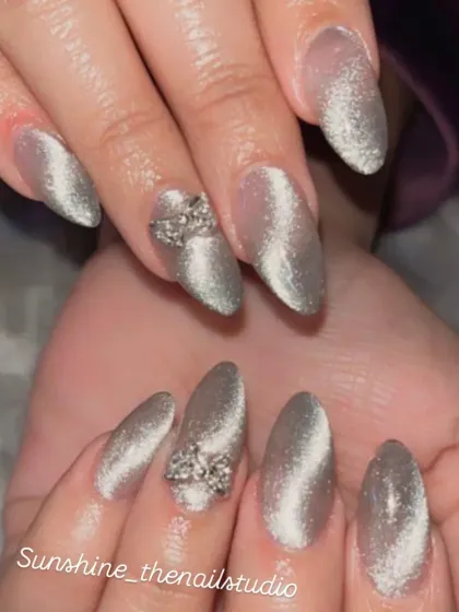Another view of the silver cat eye nails with 3D rhinestone bows.