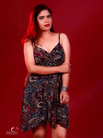 A classic three-quarter portrait. The pose is simple and elegant, allowing the dress and her presence to shine.