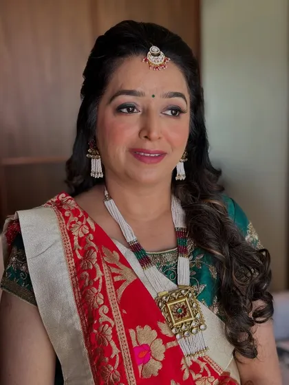 A side profile showing her beautiful jewelry and the soft, glowing finish of her makeup.