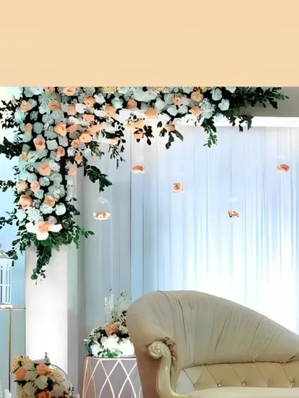 A close-up of the delicate floral arrangements and the elegant chaise lounge, showing how we combine natural beauty with refined furniture for a memorable setting.