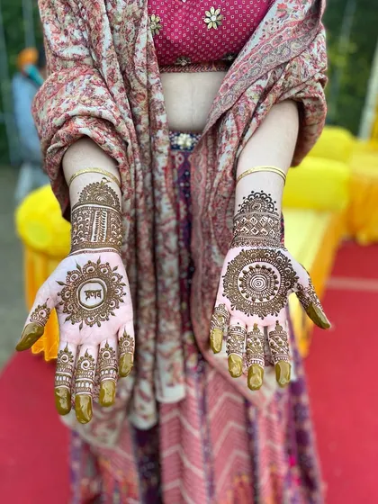 A client at a wedding event displaying her beautiful, traditional mandala designs. The mehndi is a perfect accessory to her festive attire.