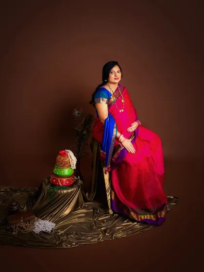To a forever of elegance. A beautiful portrait of an expecting mother in a vibrant pink and blue saree, celebrating the life she is about to bring into the world.