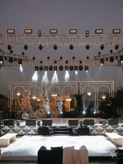 The sangeet stage was designed to feel like a high-end concert. With a massive lighting rig, golden arches, and cascading chandeliers, it was the perfect backdrop for a night of electrifying performances.