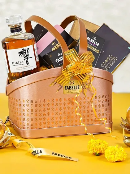 A stylish leatherette Diwali gift basket with Hibiki whisky and Fabelle chocolates. The festive diyas and clean composition make for a chic and modern gifting visual.