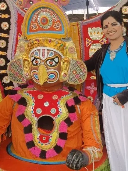 Posing with a traditional Yakshagana mask at the Karavali Utsav.