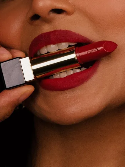 A playful and edgy shot featuring the YSL lipstick, showing the product in a bold, unconventional way.
