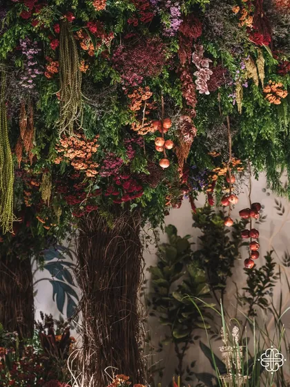 A detail of the 'Orchard of Life' decor, with fruits and flowers hanging from the handcrafted trees.