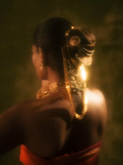 A detail shot focusing on the ornate hair accessory and the sleek bun I created for the 'Swaṟṇavalli' look. It’s these small details that complete the story.