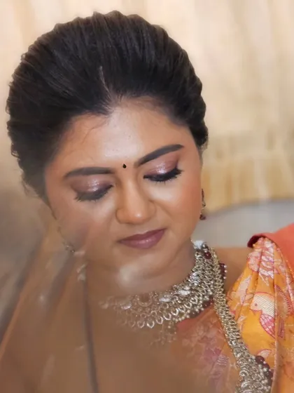 A close-up of this bride's soft and romantic eye makeup. The champagne shimmer on the lids adds a touch of modern elegance to her traditional look.