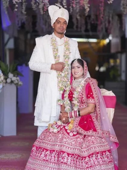 A classic portrait of the bride and groom on their wedding day. Dressed in elegant white and vibrant pink, they stand ready for their future. We ensure you have timeless, formal portraits alongside our candid shots.