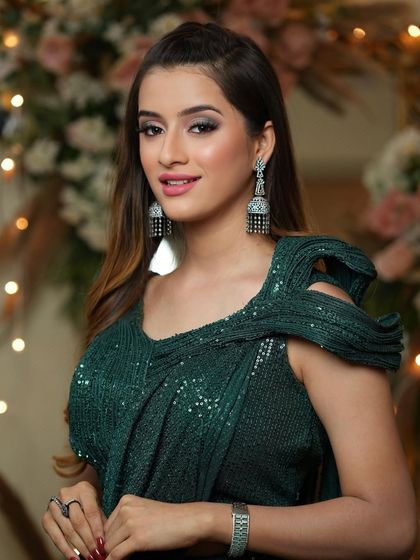 Confident and chic. This look is perfect for a modern sangeet or cocktail party, combining traditional attire with contemporary makeup.