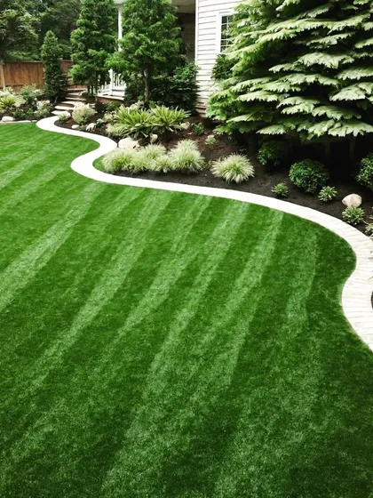 A residential front yard with a winding path and a perfectly striped lawn. The design creates a welcoming entrance to the home.