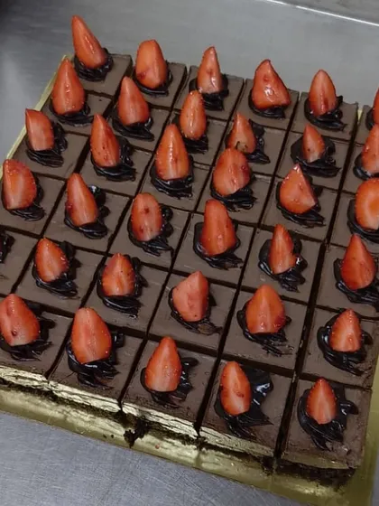 Our chocolate strawberry dessert, sliced and ready to serve. Each square is a perfect portion of fudgy, fruity goodness.