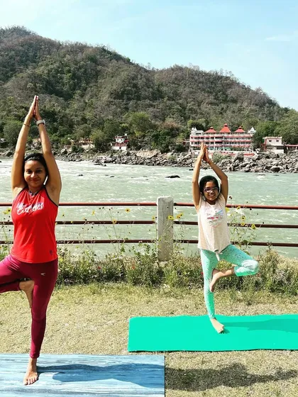 Children learn best through imitation, and sharing my practice with them is a joy. Here, we are practicing Vrikshasana, or Tree Pose, by the river. This pose helps kids improve their balance, focus, and connection to the nature around them.