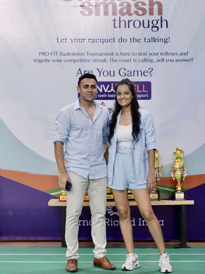 Standing with a participant in front of the event backdrop. These photo opportunities are important for capturing the moment and giving employees a great memory to share from their corporate wellness event.