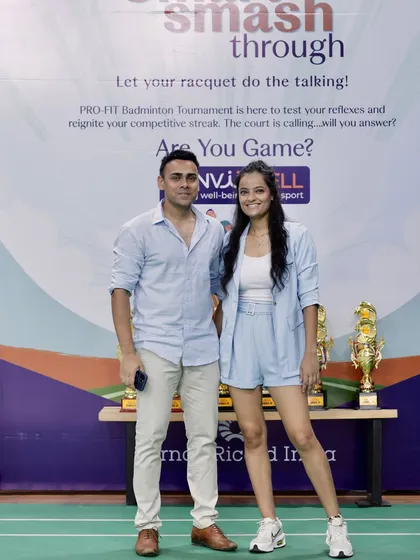 Standing with a participant in front of the event backdrop. These photo opportunities are important for capturing the moment and giving employees a great memory to share from their corporate wellness event.